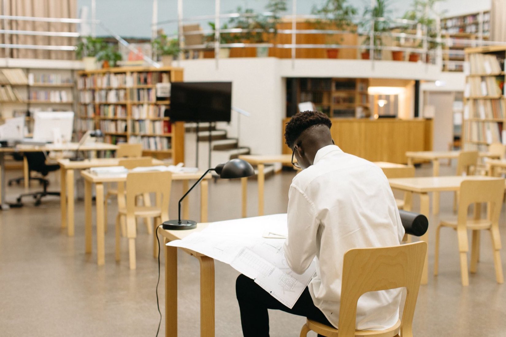 A student working at a desk in a library
