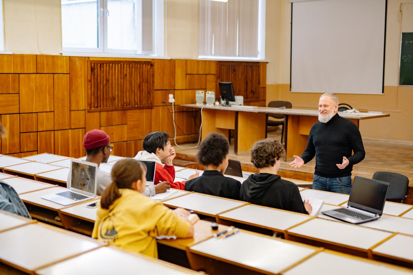 A lecturer leading a class in a lecture hall