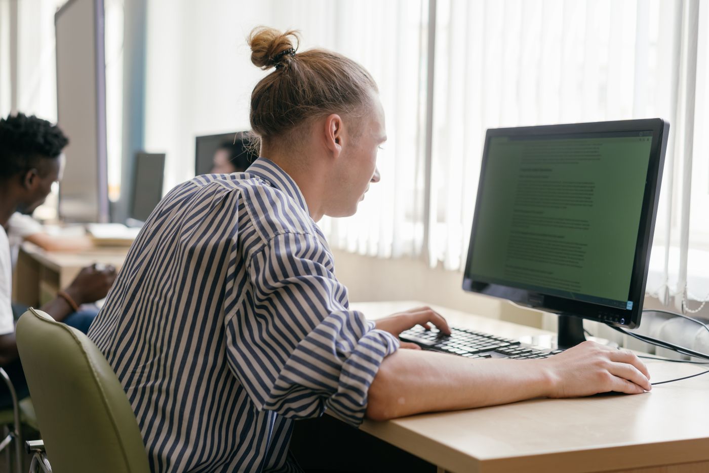A person working at a desktop computer in a lab